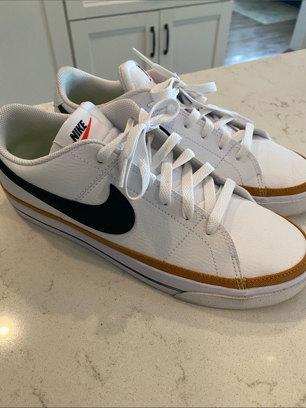 Nike Men’s White Leather Sneakers with Black Swoosh and Brown Trim